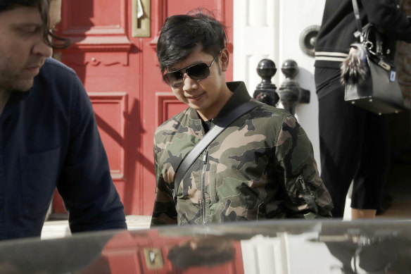 Vorayuth "Boss" Yoovidhya, whose grandfather co-founded energy drink company Red Bull, walks to get in a car as he leaves a house in London in 2017. The charges against him for a hit-and-run that killed a policeman in Thailand have been dropped.
