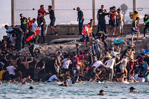Migrants try to cross from Morocco into the Spanish enclave of Ceuta.