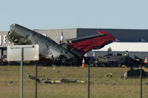 Debris from two planes that crashed during an airshow at Dallas Executive Airport lie on the ground .