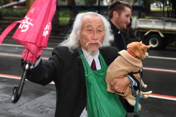 Activist Danny Lim with his chihuahua-pomeranian dog Smarty outside Downing Centre Local Court in Sydney on Friday,