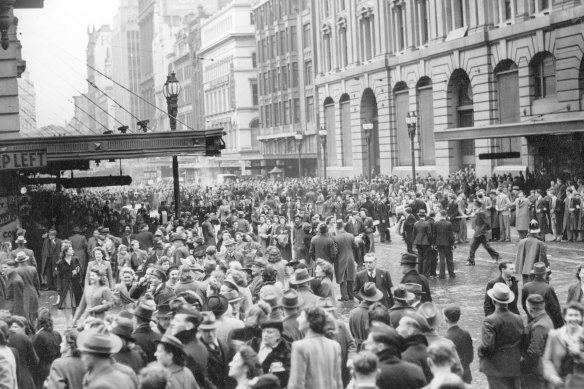 Crowds gather in Bourke and Elizabeth Streets to hear the news.