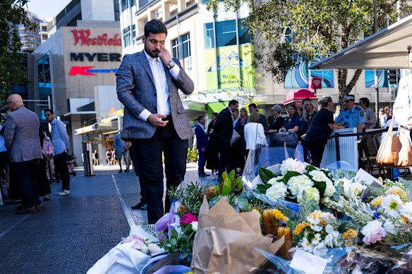 Surviving security guard Muhammad Taha sheds a tear as he lays a bouquet at the memorial on the anniversary of the attack.