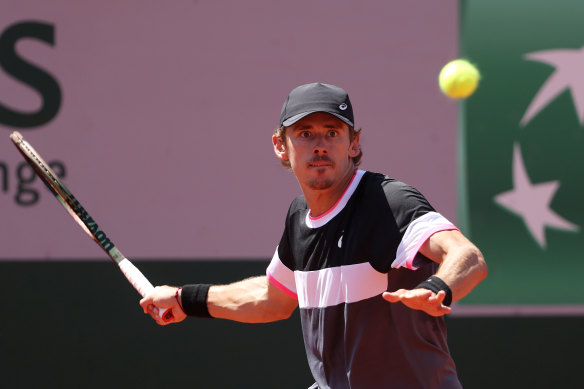 Alex de Minaur returns the ball to Tomas Martin Etcheverry during their second-round clash.