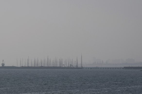 The view across Port Phillip Bay from Brighton on Sunday as haze lingered over Melbourne.