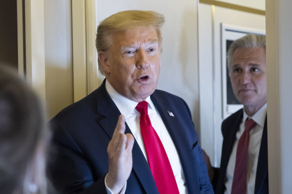 President Donald Trump speaks with reporters while in air en route to Andrews Air Force Base.