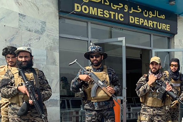Taliban fighters stand guard inside the Hamid Karzai International Airport after the US withdrawal in Afghanistan. 