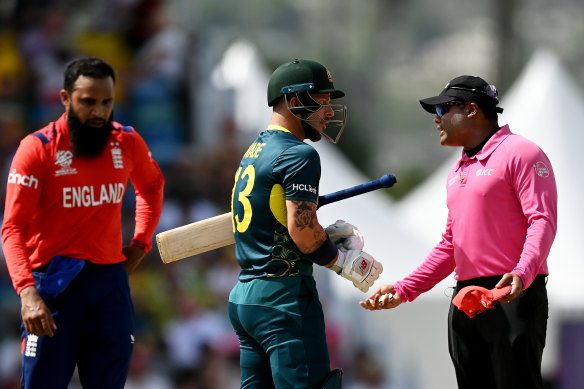 Matthew Wade speaks to umpire Nitin Menon after a delivery he felt should have been a dead ball.