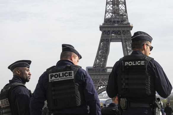 Police officers patrol the Trocadero plaza near the Eiffel Tower in October 2023. Security authorities have foiled a plan to attack soccer events during the Paris Olympics.