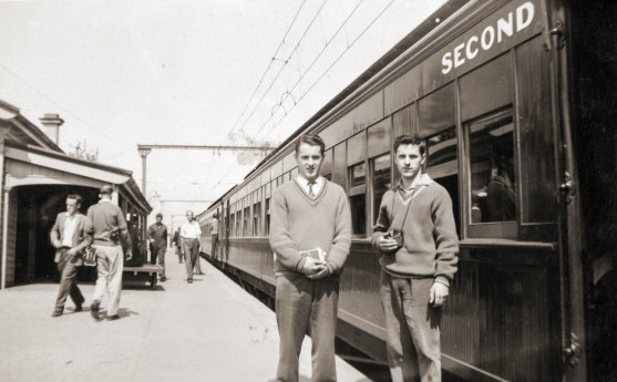 Train enthusiasts even then, Tom Clark, left, and his twin brother Kevin in the 1960s next to a steam-hauled train they travelled on.