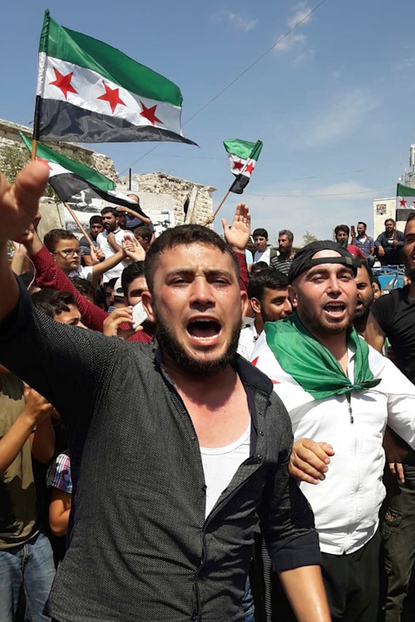 Protester in Harim, a town in Idlib province, fly the rebel flag earlier this month.
