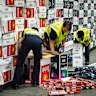 The Australian Border Force officers check illegal cigarette imports found in shipping containers in Melbourne.