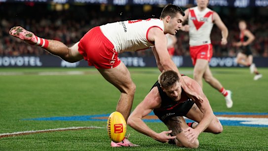 MELBOURNE, AUSTRALIA - AUGUST 16: Logan McDonald of the Swans and Jayden Laverde of the Bombers contest the ball during the round 23 AFL match between Essendon Bombers and Sydney Swans at Marvel Stadium, on August 16, 2024, in Melbourne, Australia. (Photo by Daniel Pockett/Getty Images)
