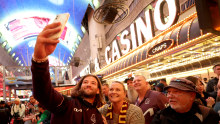 Pat Carrigan of the Brisbane Broncos takes a selfie with fans during the NRL season launch at Fremont Street Experience on February 29, 2024, in Las Vegas, Nevada. 