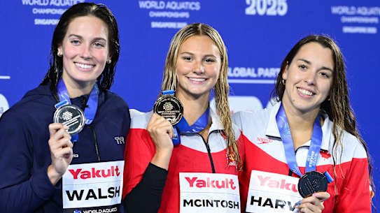 Canada’s Summer McIntosh (centre) celebrates her gold medal in the women’s 200m individual medley at the world swimming championships in Singapore. 
