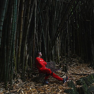 A resident of We Help Ourselves immerses himself in the tranquility of the bamboo forest at Callan Park.