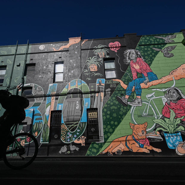 Cycling past a mural in Brougham Street.