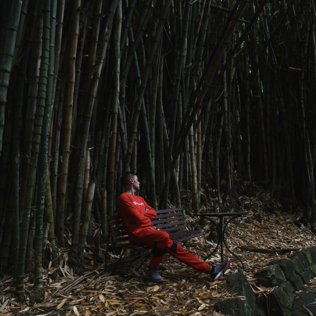 A resident of We Help Ourselves soaks in the tranquillity of the bamboo forest in Callan Park.