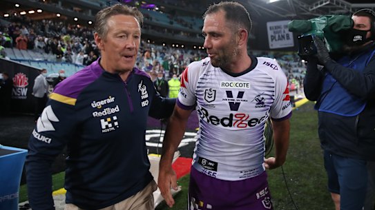 Storm champion Cameron Smith and Craig Bellamy celebrate after last year’s grand final win. 