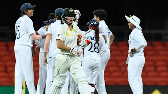 Beth Mooney walks off the field after being dismissed during day four of the women’s international Test between Australia and India at Metricon Stadium.