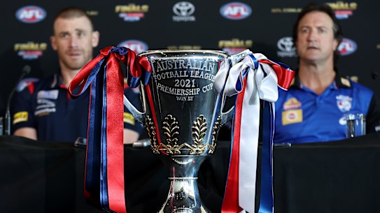 Melbourne coach Simon Goodwin and Bulldogs counterpart Luke Beveridge flank the premiership cup on Friday.