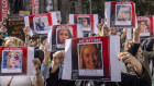 Protesters hold placards of women who were killed in alleged incidents of gender-based violence.