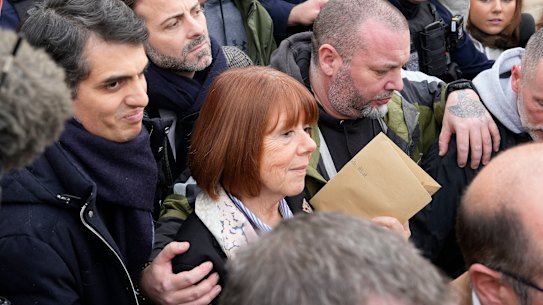 Gisele Pelicot leaves the courthouse next to her lawyer Stephane Babonneau, left.