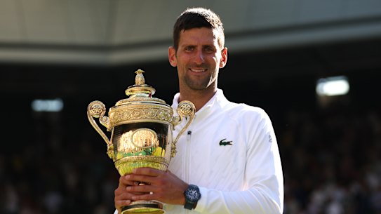 Novak Djokovic of Serbia poses for a photo with the trophy following his victory against Nick Kyrgios of Australia during their Men’s Singles Final match on day fourteen of The Championships Wimbledon 2022 at All England Lawn Tennis and Croquet Club on July 10, 2022 in London, England. (Photo by Clive Brunskill/Getty Images)