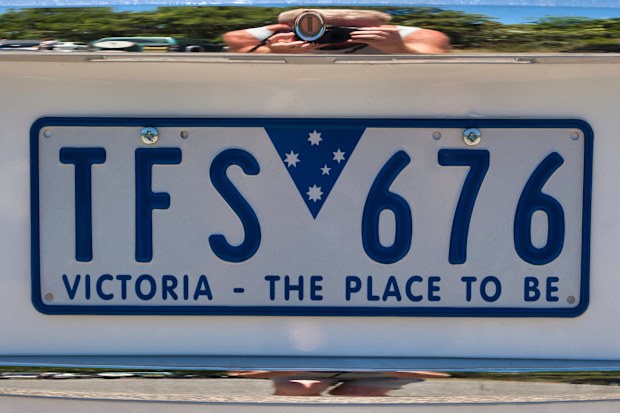 Close up of a vehicle number plate with the slogan saying Victoria, the place to be, under the license numbers. Melbourne, Victoria, Australia. January 11 2018