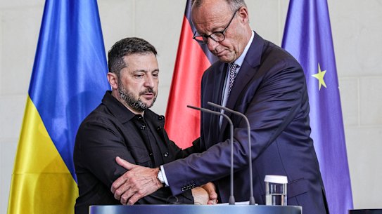 German Chancellor Friedrich Merz and Ukrainian President Volodymyr Zelensky shake hands at the end of a joint press conference at the Chancellery following a virtual meeting hosted by Merz between European leaders and US President Donald Trump in Berlin, Germany.