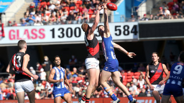 Peter Wright of the Bombers and Tristan Xerri of the Kangaroos compete.