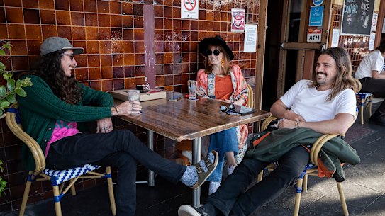 Locals drink at tables outside the Bells Hotel in Woolloomooloo during warm weather.