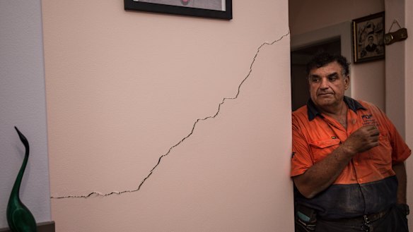 Umberto Galasso pictured with a crack he says opened up or widened after excavation works for WestConnex beneath his North Strathfield home. 