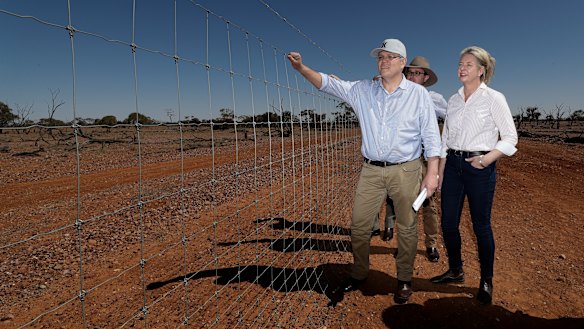 Prime Minister Scott Morrison, is joined by colleagues David Littleproud and Bridget McKenzie inspect a dog-proof fence at Quilpie during a drought tour in south-west Queensland.