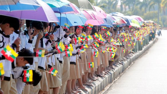 Supporters line up to welcome Myanmar leader Aung San Suu Kyi back from the Netherlands where she was defending her country from charges of genocide.