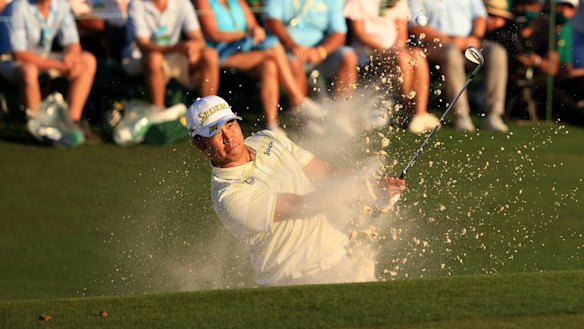 Hideki Matsuyama plays out of the bunker on the 18th hole.