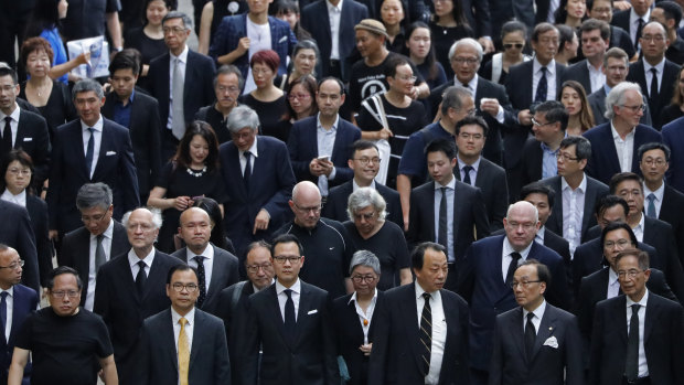 Hundreds of legal professionals wear black to express their disappointment as they participate in a silent march to protest against the extradition bill in Hong Kong.