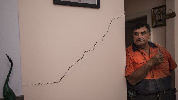 Umberto Galasso pictured with a crack he says opened up or widened after excavation works for WestConnex beneath his North Strathfield home. 
