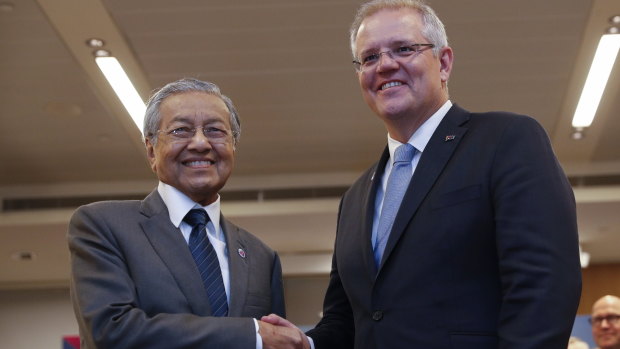 Malaysian Prime Minister Mahathir Mohamad shakes hands with Prime Minister Scott Morrison during a bilateral meeting on Thursday at ASEAN.