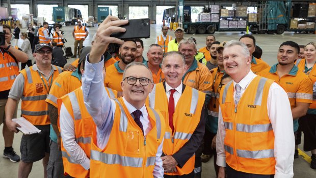 Opposition Leader Anthony Albanese takes a selfie with workers during a visit to the Toll NQX national office in Berrinba, Queensland.