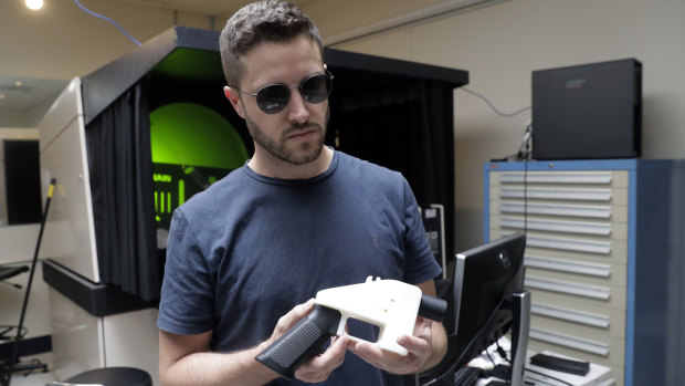 Cody Wilson holds a 3D-printed gun called the Liberator at his shop on Wednesday.