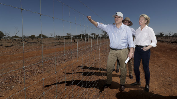 Prime Minister Scott Morrison, is joined by colleagues David Littleproud and Bridget McKenzie inspect a dog-proof fence at Quilpie during a drought tour in south-west Queensland.