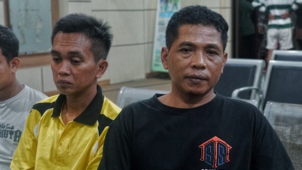 Bejo Santoso (right) with Muhamad Kholil, who is waiting for news on his missing wife, Siti.