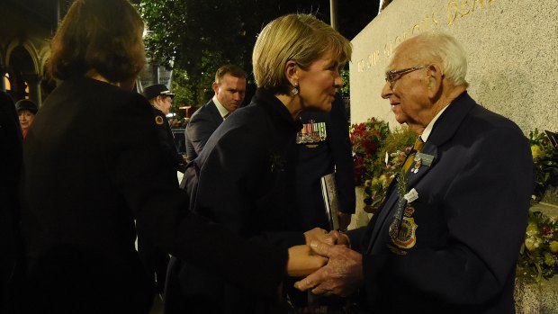 Australian Bishop kisses Custodian of the Cenotaph Wal Scott-Smith after completing his 78th Anzac Day dawn service at the cenotaph in Martin Place, Sydney.