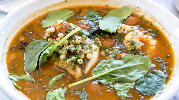 The fish stew with fregola, cherry tomatoes, olives and capers.