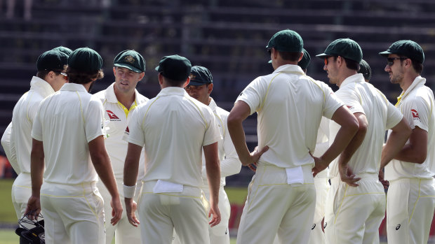 Australian players get together  before the start of play in the fourth Test against South Africa.