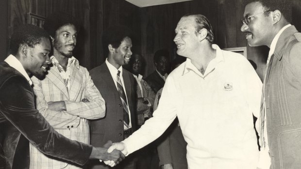 Kerry Packer meets the West Indies cricket team, among them Clive Lloyd to his left and opposite him with his arms folded, Michael Holding, as World Series Cricket gets going in 1977.