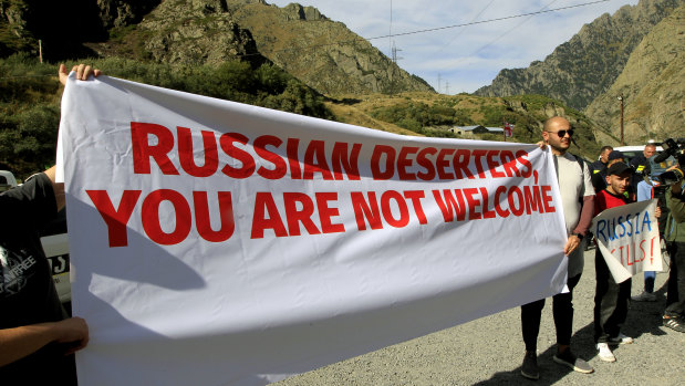 Activists hold an anti-Russian banner  at the Georgia-Russian border during an action organised by political party Droa near the border crossing at Verkhny Lars between Georgia and Russia in Georgia. Wednesday