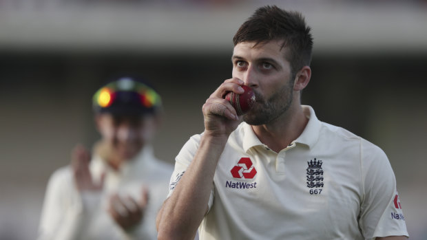 England's Mark Wood kisses the ball after taking five wickets against the West Indies.