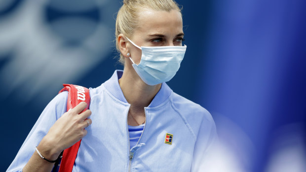 A masked Petra Kvitova enters the court before her match against Karolina Muchova.