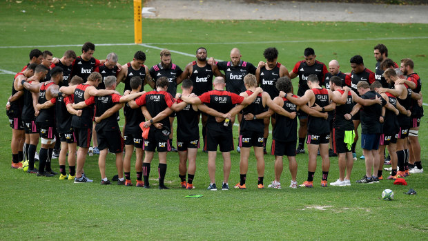 Quiet reflection: Crusaders players and staff pause during their captain's run on Friday in Sydney to remember those who lost their lives in the Christchurch terrorist attack. 